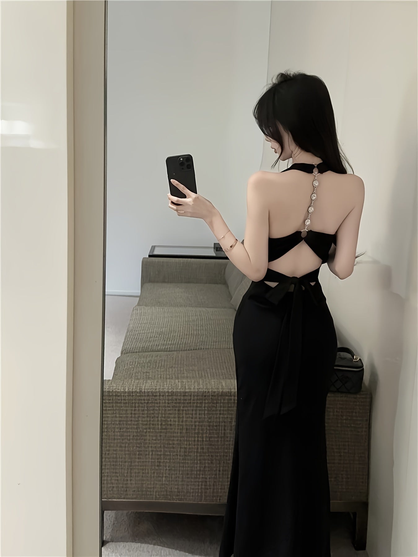 A Black Designer Chain Neck Strap Backless Dress for Women, Featuring a Sexy, Fitted Silhouette with a Mermaid Hem And Built-In Padding, Perfect for Summer.